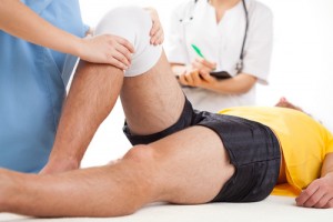 Doctor checking a knee recovering in hospital